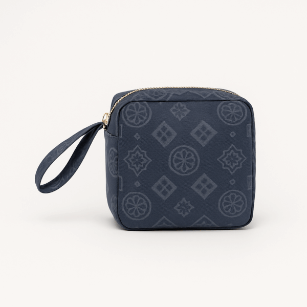 maison_haya_prayer_dress_travel_blue_pouch Navy blue Travel Prayer Set pouch with tonal petal medallion print, gold zip and wrist strap — Petal, Maison Haya