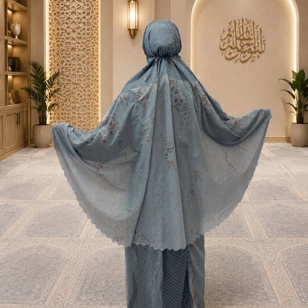 Woman wearing the blue floral pocket prayer dress in a prayer room — Maison Haya